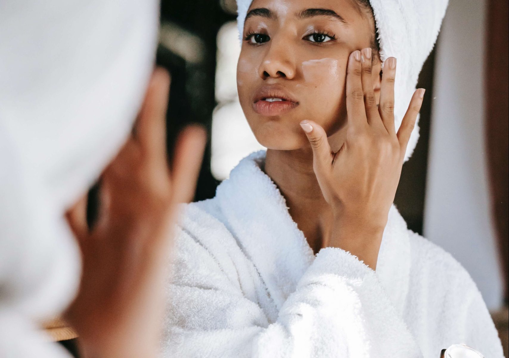 An african lady caring for her face with natural skin products